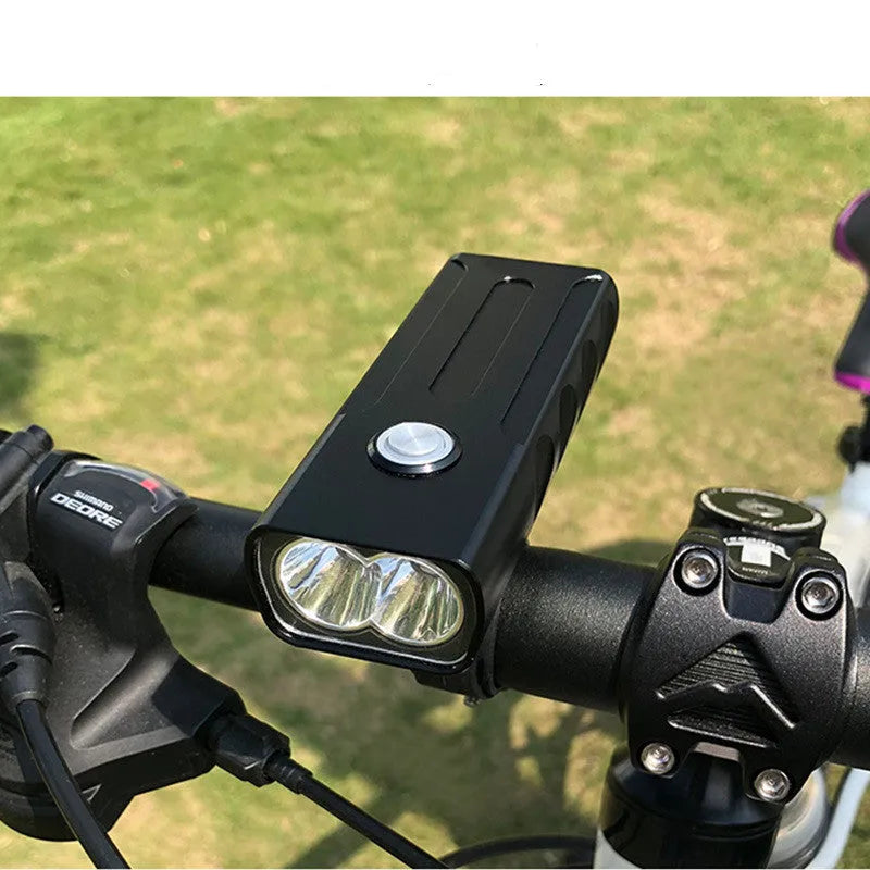Black rechargeable bicycle headlight with aluminium alloy body and 360-degree bracket on handlebars