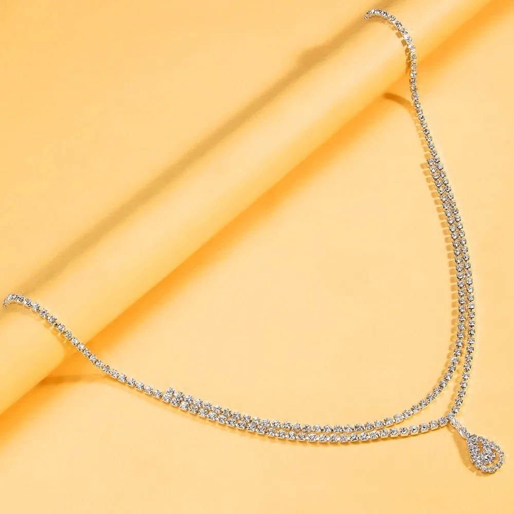 Gold water drop pendant waist chain with tassel on a 115cm adjustable chain.