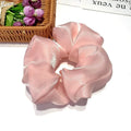 Korean style cloth hair ring with crystal satin finish in light pink colour on a white background