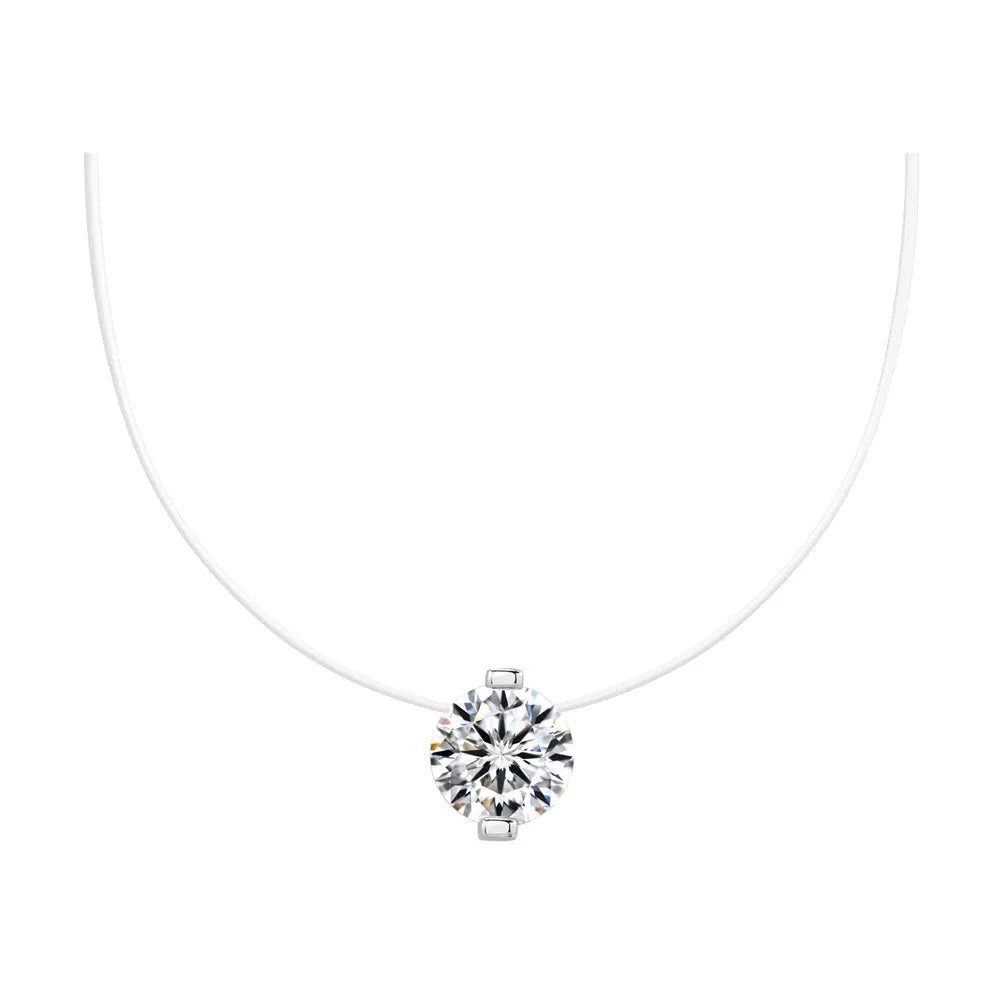Close-up of a women's sterling silver plum blossom pendant with a blue green moissanite on an invisible fishing line necklace.