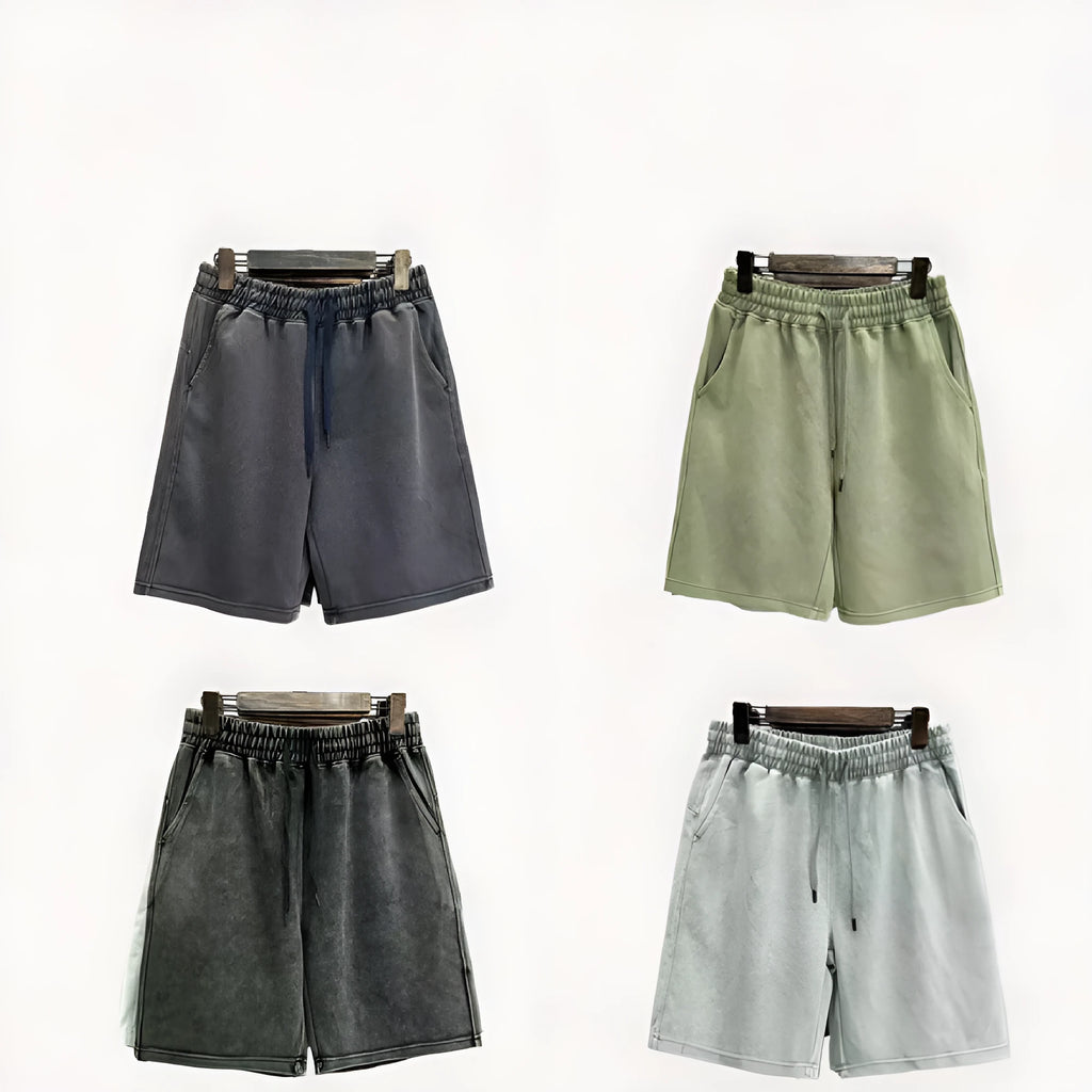 Man wearing solid colour distressed cotton shorts with a loose casual straight-leg fit