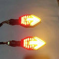 Arrow-shaped LED motorcycle indicator lights showing yellow with blue, red, or white lighting options