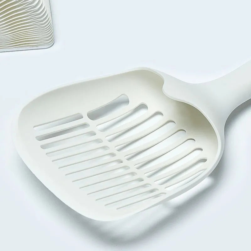 White plastic cat litter scoop with storage base for containing tool between uses