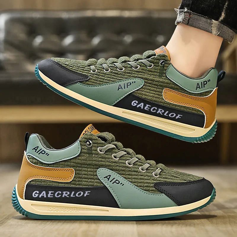 Men's green and grey running shoes with mesh upper and lace-up closure on neutral background