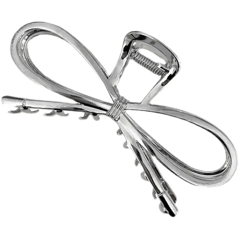 Gold bow barrette hair grip with alloy construction and decorative design