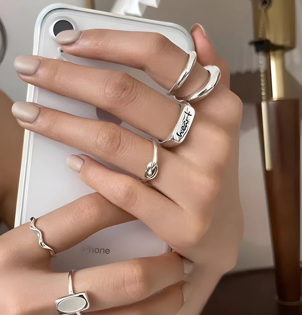 Korean-style 925 sterling silver minimalist ring for women with adjustable opening on a plain background