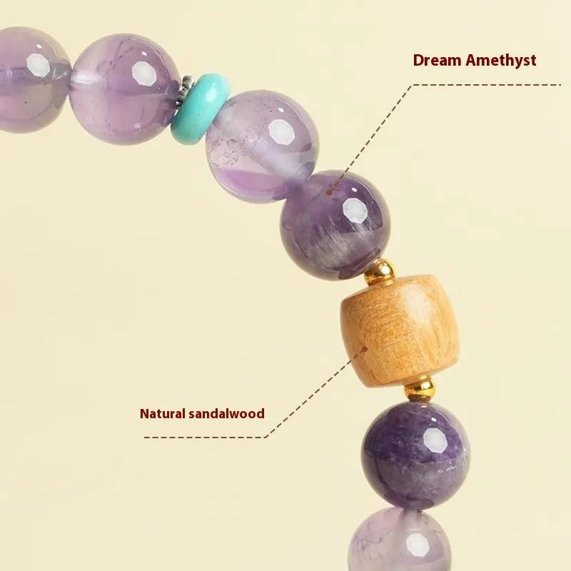 Handmade purple amethyst crystal bracelet for women on a wrist.