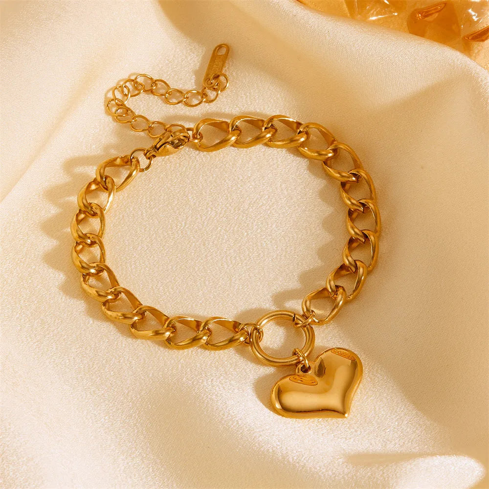 Titanium steel round chain bracelet with heart charm and petal detailing in gold N510