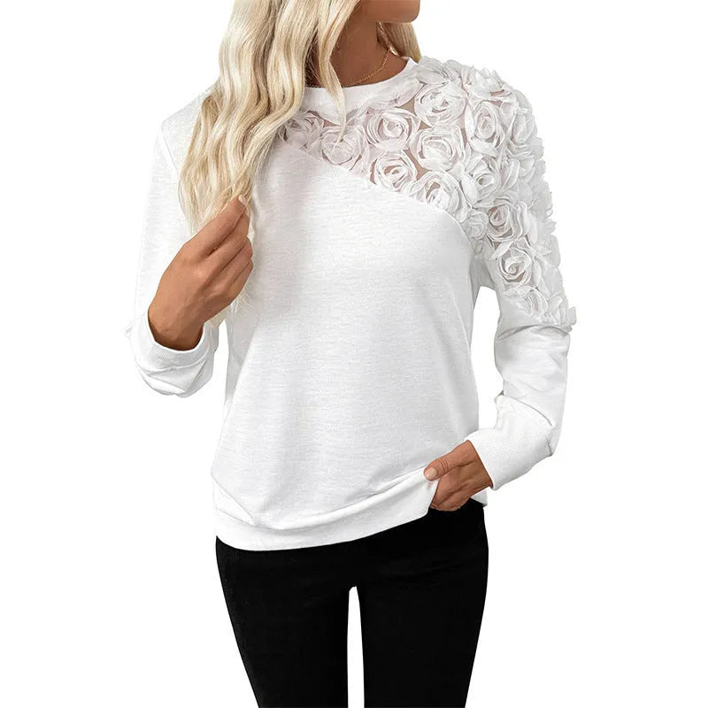 White long sleeve women's top with floral pattern, loose fit pullover style.