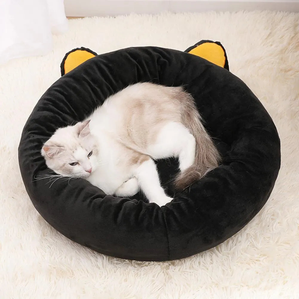 Black cat-shaped velvet pet nest bed with raised edges, shown in small and medium sizes.