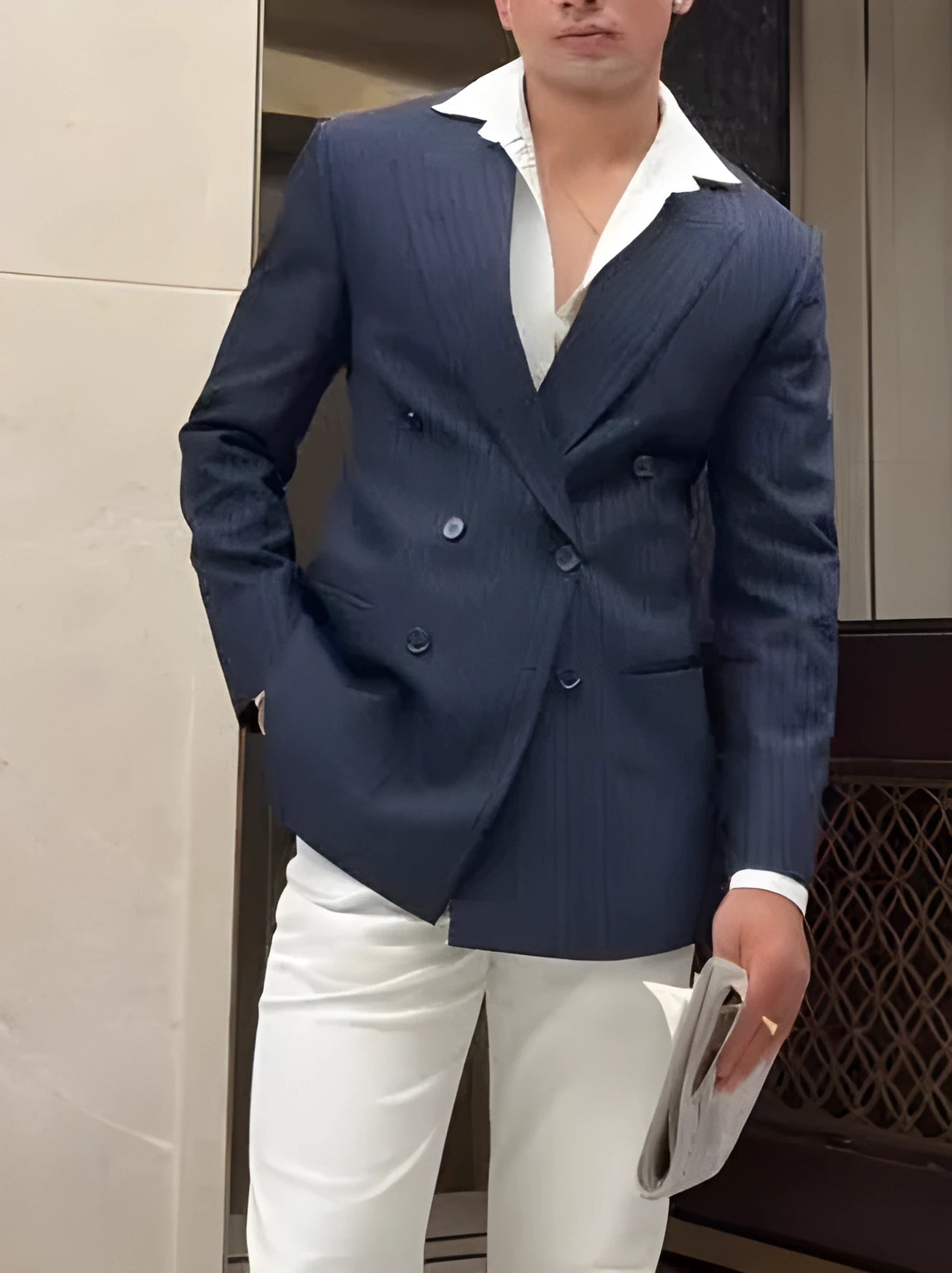 Men's striped double-breasted polyester blazer on hanger showing regular fit design
