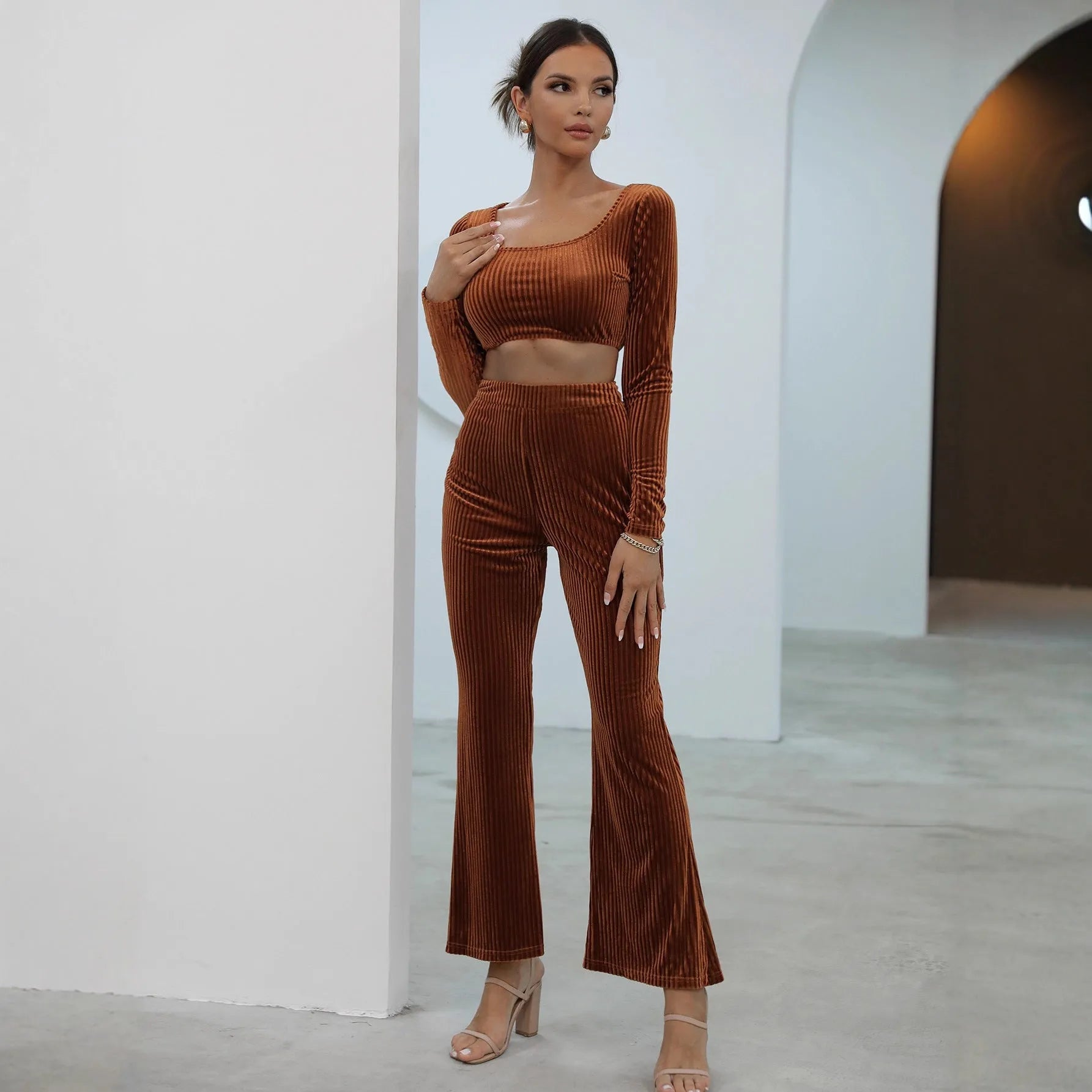 Caramel coloured long sleeve sweater and trousers co-ord set on a hanger