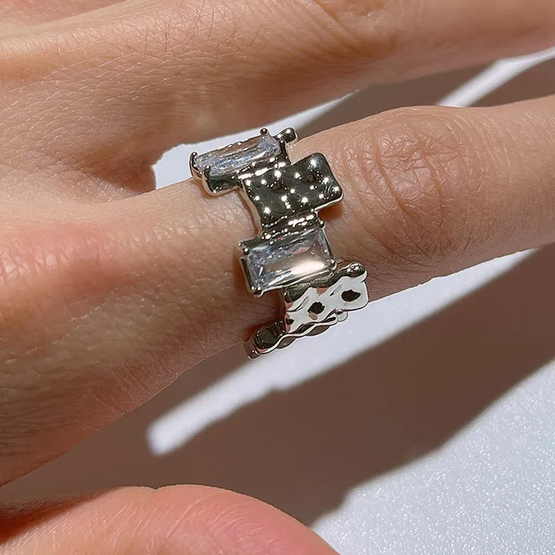 Geometric open ring with zircon stones and silver-plated finish