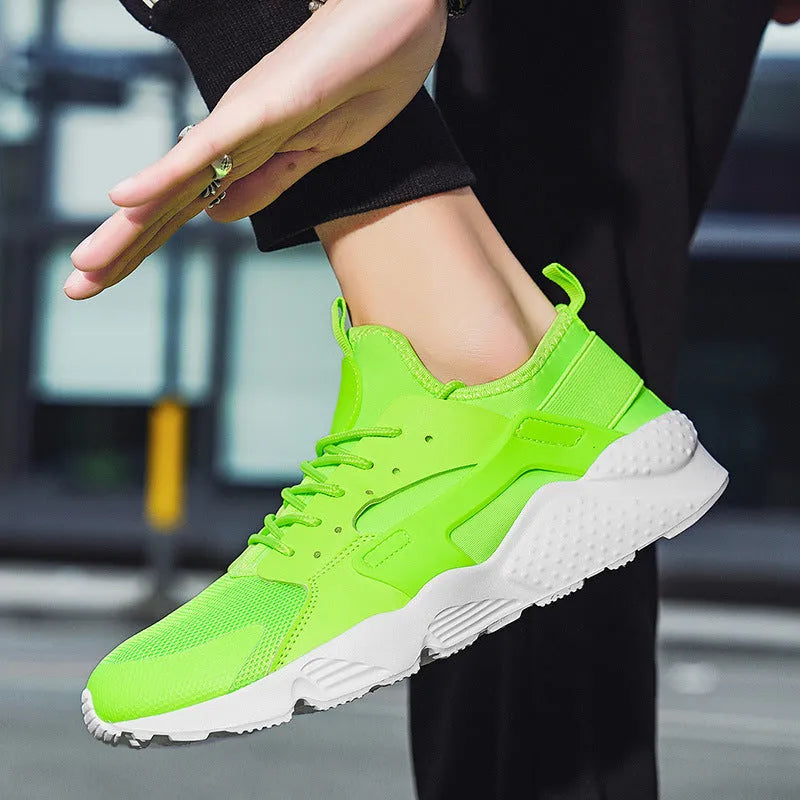 Men's fluorescent red mesh casual trainers with cross shoulder straps and white laces on a flat MD sole.
