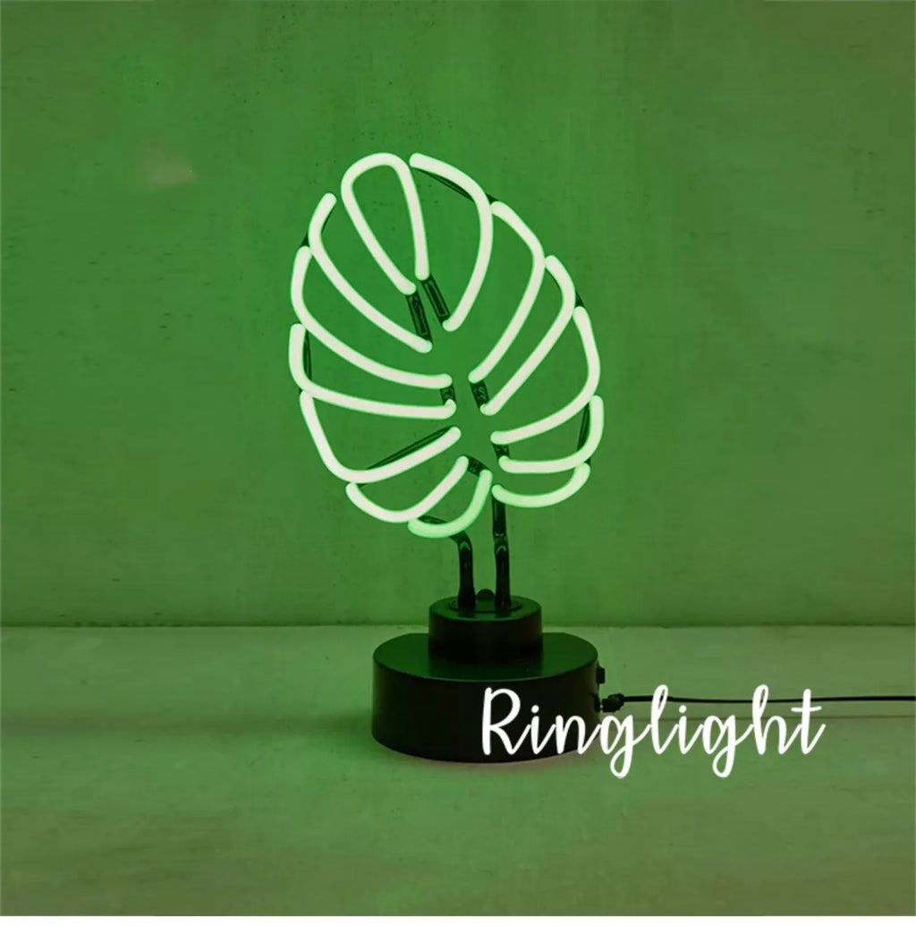 White minimalist bamboo-shaped desk lamp with green light, showing large and small size options.