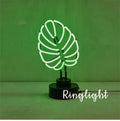 White minimalist bamboo-shaped desk lamp with green light, showing large and small size options.
