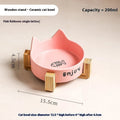 Porcelain cat bowl with cat ear and paw design on a wooden feeding frame, in pink colour.