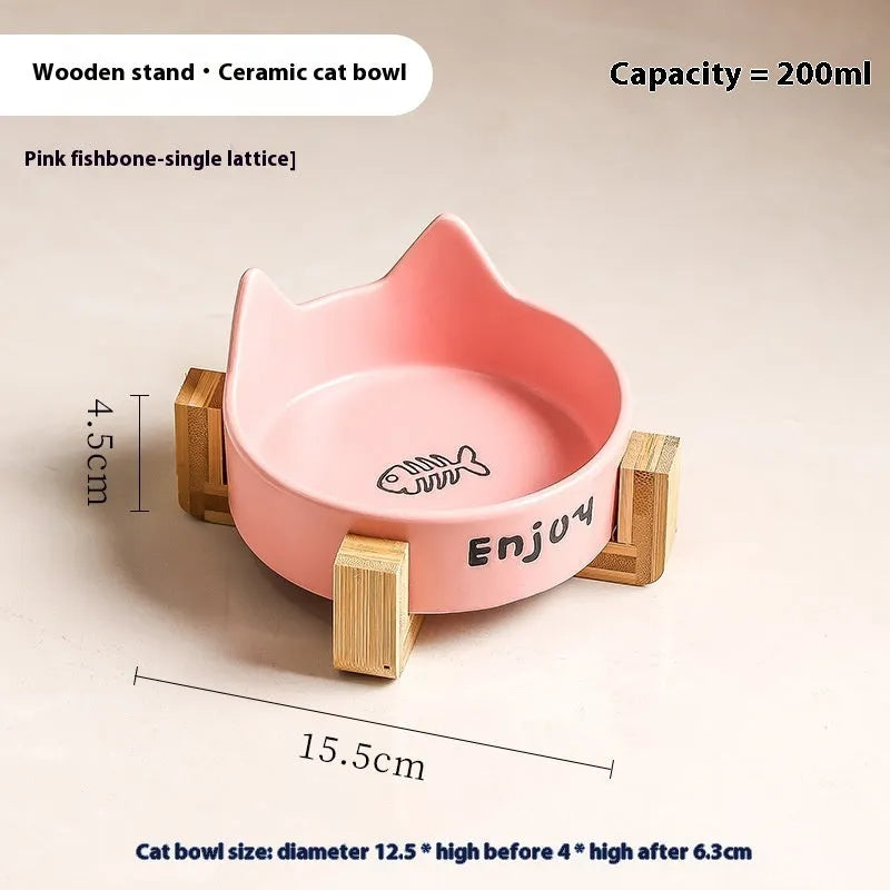 Porcelain cat bowl with cat ear and paw design on a wooden feeding frame, in pink colour.
