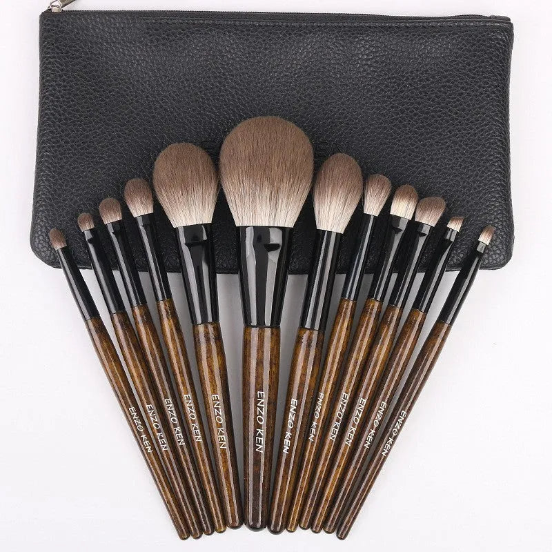 12-piece makeup brush set with wooden handles displayed in open PU brush roll