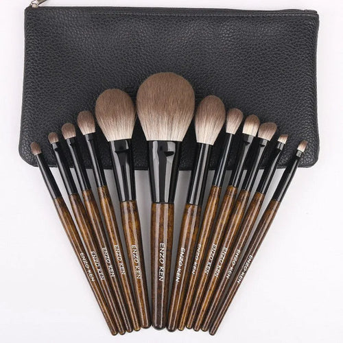 12-piece makeup brush set with wooden handles displayed in open PU brush roll