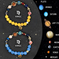 Two natural stone beaded bracelets featuring engraved zodiac signs on a wooden surface.
