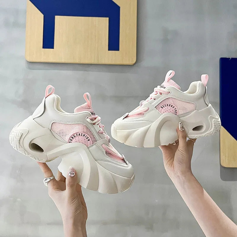 Women's beige casual sneakers with cross straps, thick sole, and mesh lining on a white background.