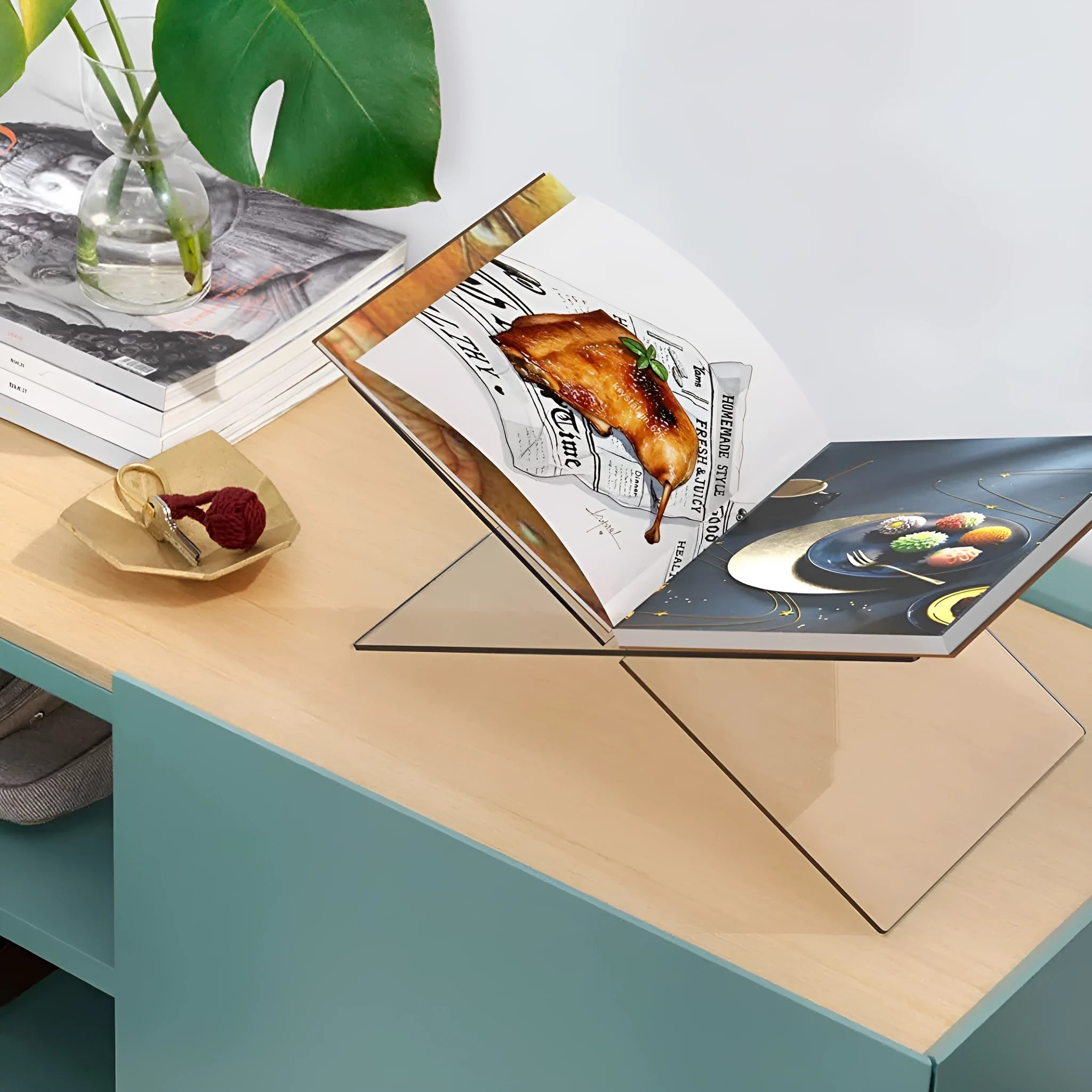 Clear acrylic X-shaped book display shelf holding books at an angle