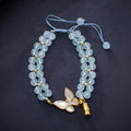 Close-up of a handmade women's woven bracelet with 6mm butterfly design in aquamarine gemstone beads.