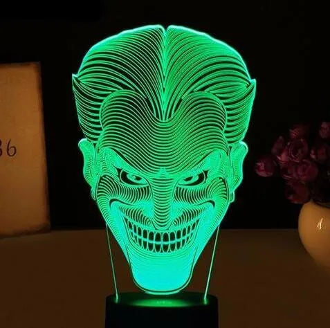 USB-powered 3D LED desk lamp showing multiple colour modes on an acrylic panel with a remote control.