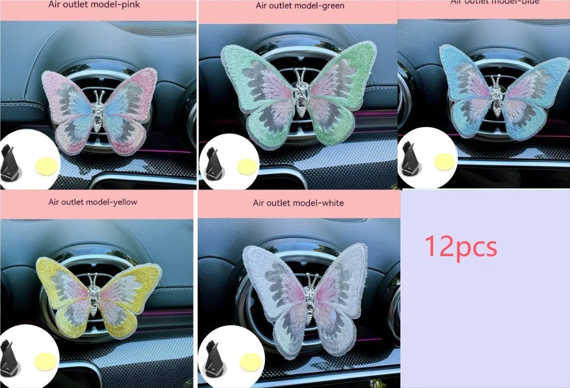 Soft fabric embroidered butterfly car air vent decoration in multiple colour options on a centre console.