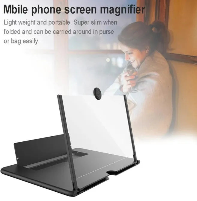 Black foldable phone screen amplifier with fenier lens, 3-4x magnification, on a table