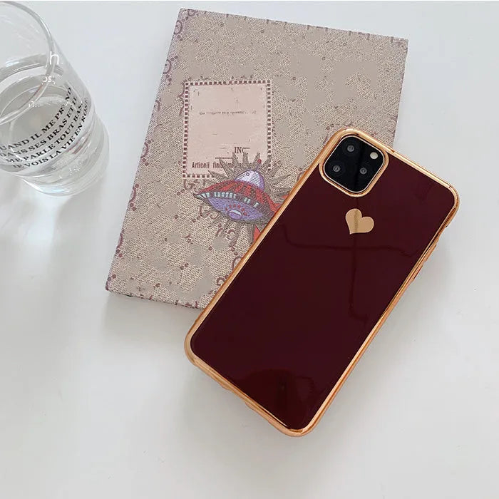 Luxury plating love solid colour TPU back cover case for iPhone on a table.
