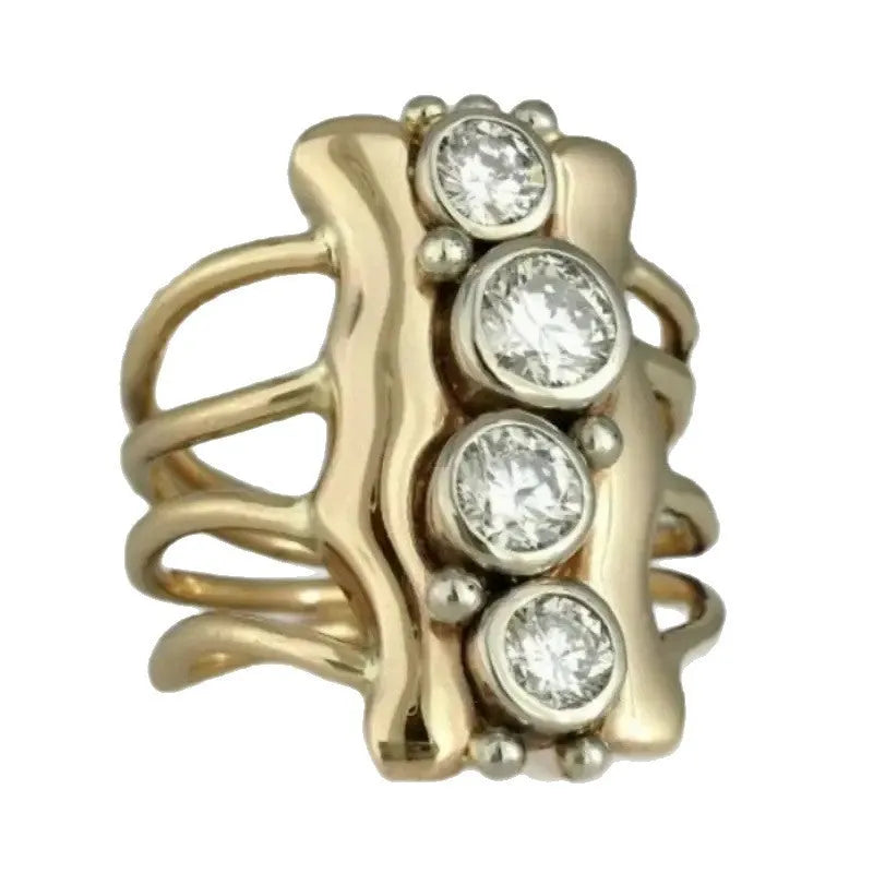 Gold electroplated zinc alloy retro creative fashion ring for women on a plain background