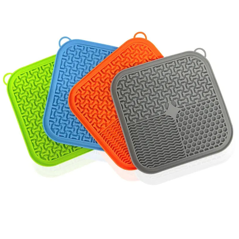 Square orange and grey silicone dog licking mat with textured surface and suction cups on the back.