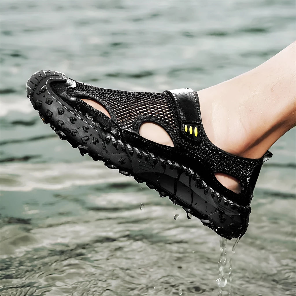 Men's casual sandals with black mesh upper, rubber sole, and adjustable Velcro strap.