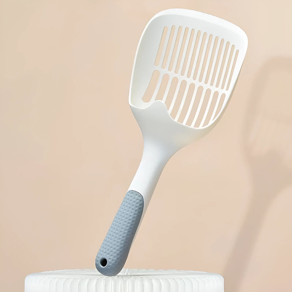 White plastic cat litter scoop with storage base for containing tool between uses