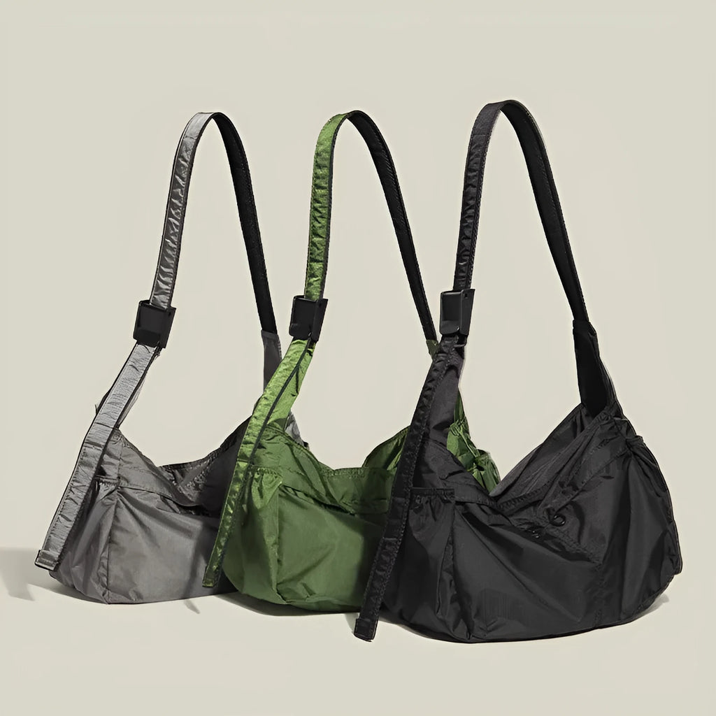Large black nylon waterproof messenger bag with shoulder strap showing horizontal square shape