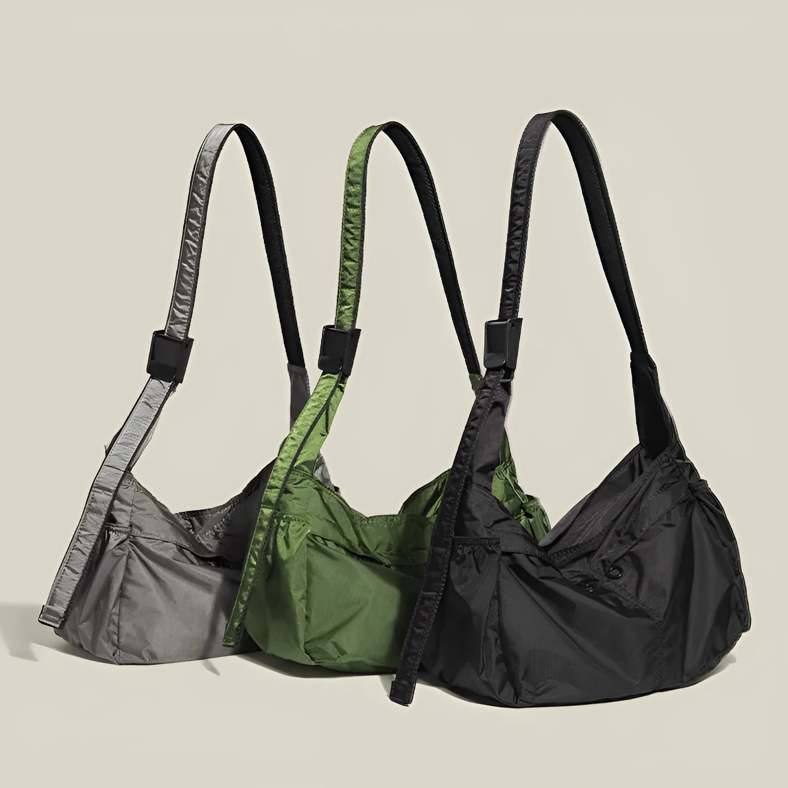 Large black nylon waterproof messenger bag with shoulder strap showing horizontal square shape
