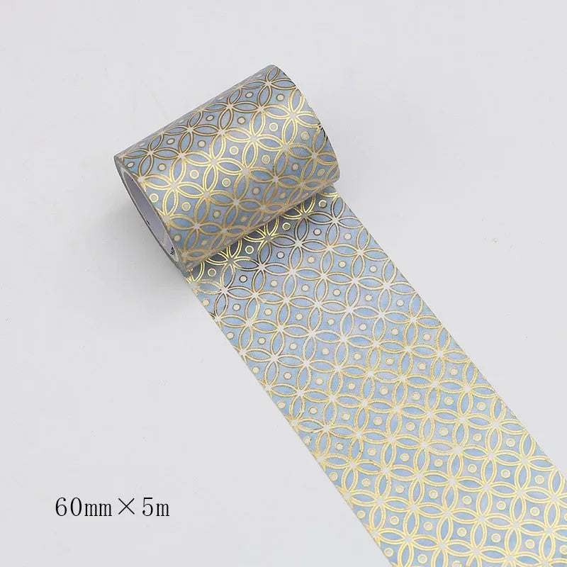 Roll of bronzing and paper decorative tape in gold colour, showing metallic finish.