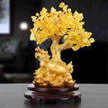 Citrine resin turtle money tree Feng Shui ornament on a white background.