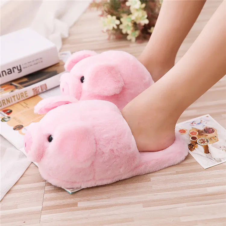 Pink pig-shaped plush floor slippers with PP cotton filling on a plain background