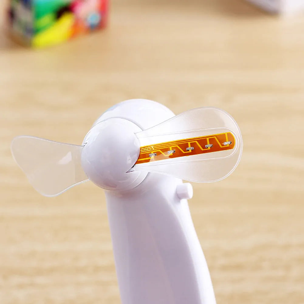 White handheld mini fan displaying a red flashing 'I Love You' LED pattern on its front panel.