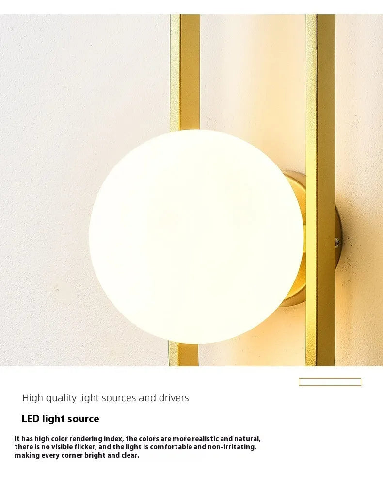 Minimalist wall-mounted lamp with clear glass bulb shade on a black iron sconce arm and backplate.