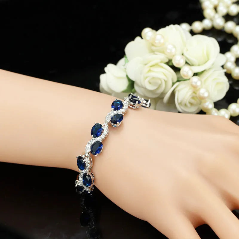 Geometric gold electroplated women's bracelet with inlaid AAA+ zircon stones on a copper base.