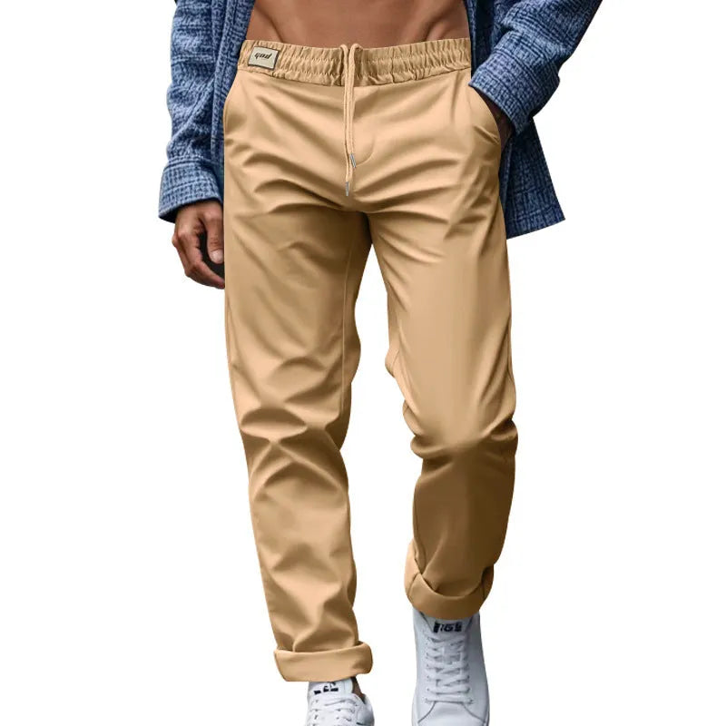 Men's casual trousers in solid grey, loose fit with drawstring waist and side pockets, full length