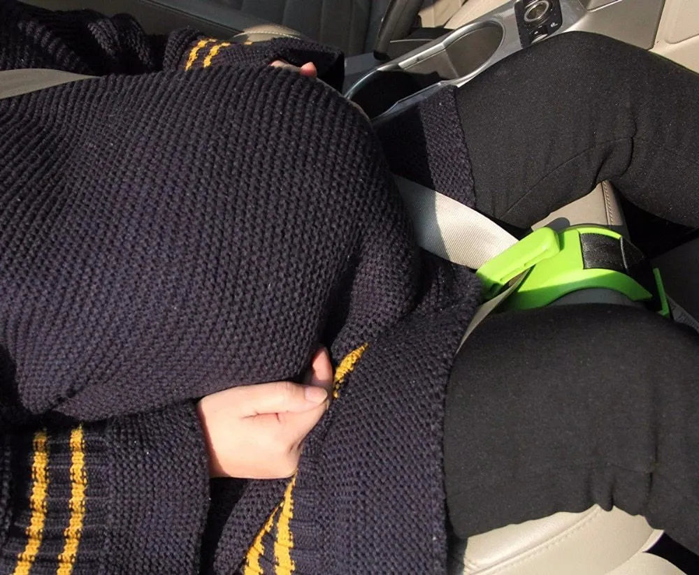 ZUWIT maternity car seat belt adjuster in white plastic attached to a seat belt, redirecting it away from the belly