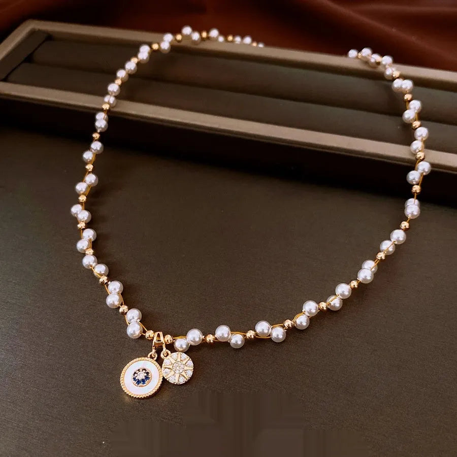 Gold electroplated necklace with round zircon and imitation pearl pendant on clavicle chain