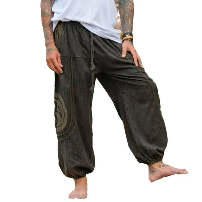 Men's dark green ethnic pattern casual ankle-tied trousers on model, polyester fabric