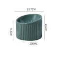 Dark green ceramic elevated cat bowl with tilted design on a raised platform.