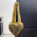 Women winter fleece heart shape crossbody bag with plush exterior, tassel detail, and large capacity
